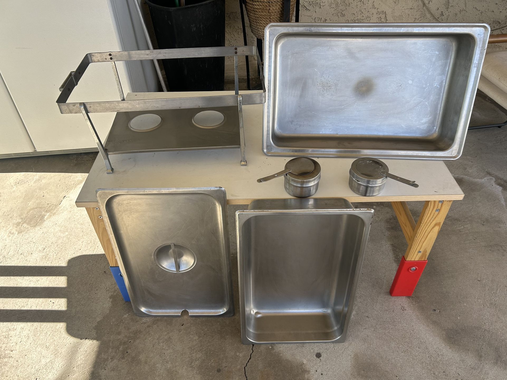 This is a set of stainless steel steam table pans, also known as hotel pans, which are standard commercial kitchen equipment.