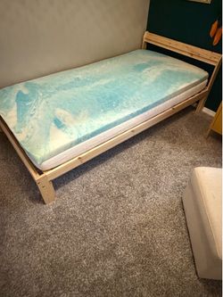 Twin wooden bed frame, mattress, and mattress topper