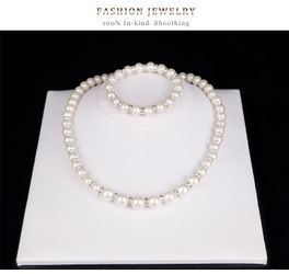 Set of imitation pearls contains (earrings, necklace and bracelet)