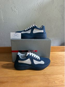 White and navy blue Prada cups