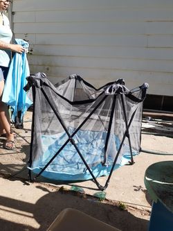 Fenced in playpen with half shade umbrella