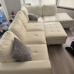 white L shape couch with ottoman 