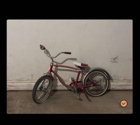 Small schwinn red lowrider bike