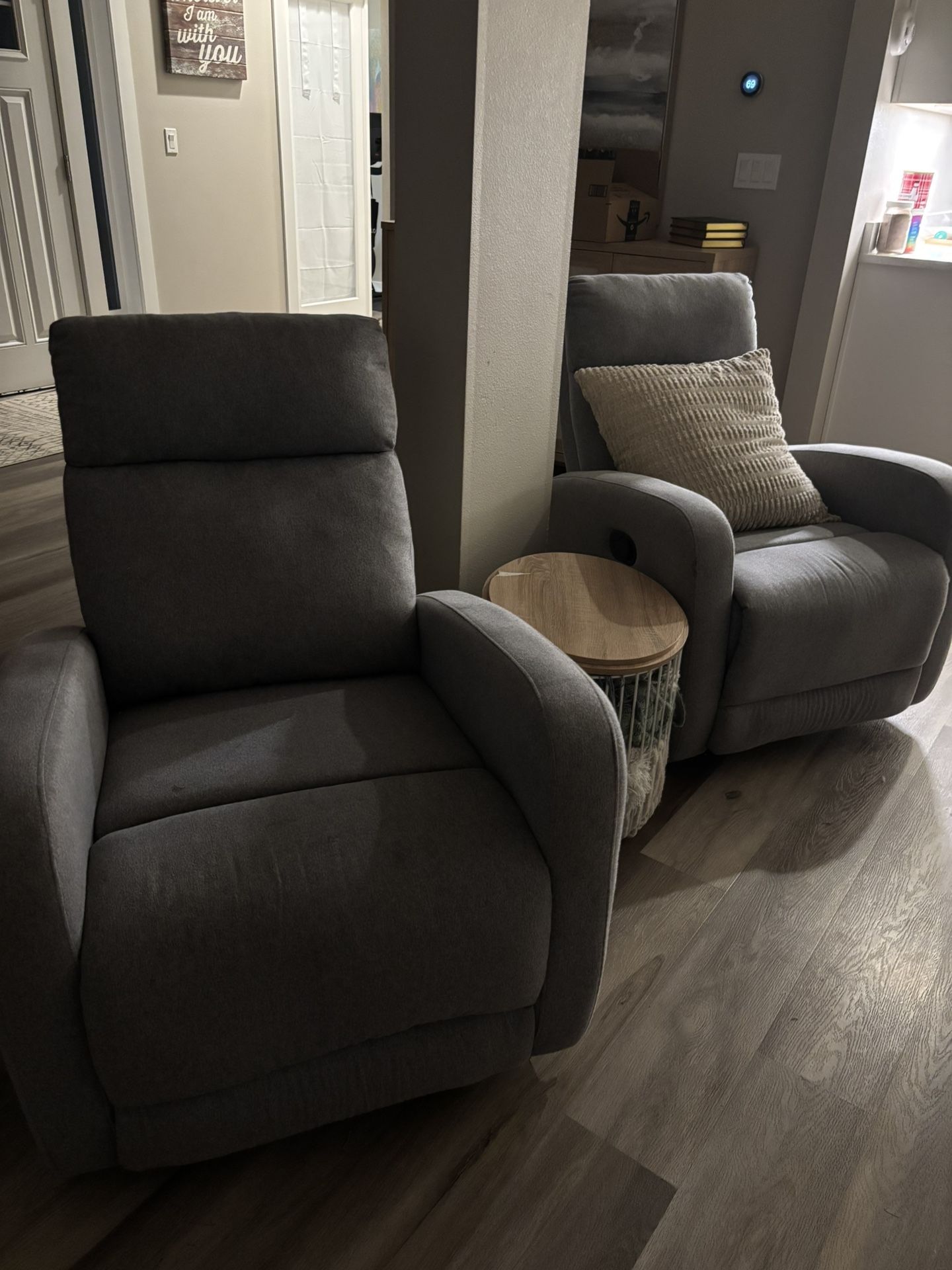 Two light grey swivel recliners