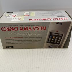 The item in the image is a Meyer Compact Alarm System, a vintage electronic security device