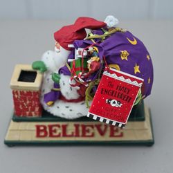Santa with believe carrying sack on chimney