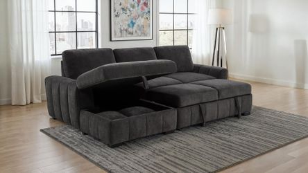 Wide track arms sectional features pull out bed w/Storage and Relaxed Chaise Layout