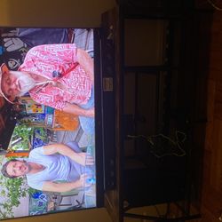 55 inch TCL tv with soundbar and stand table