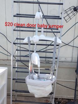 Very clean baby jumper hanging from the door frame