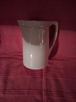 Vintage white water pitcher.\nSeven inches by ten inches