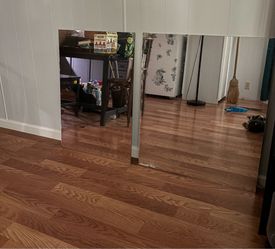 Two frameless rectangular mirrors for sale, one larger and one smaller.