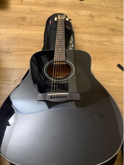 Yamaha autistic guitar with a strap and guitar case