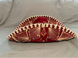 This Pigalle sombrero is crafted from red velvet and features intricate gold embroidery with colorful sequin accents