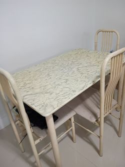 4 chairs and table with formica top.