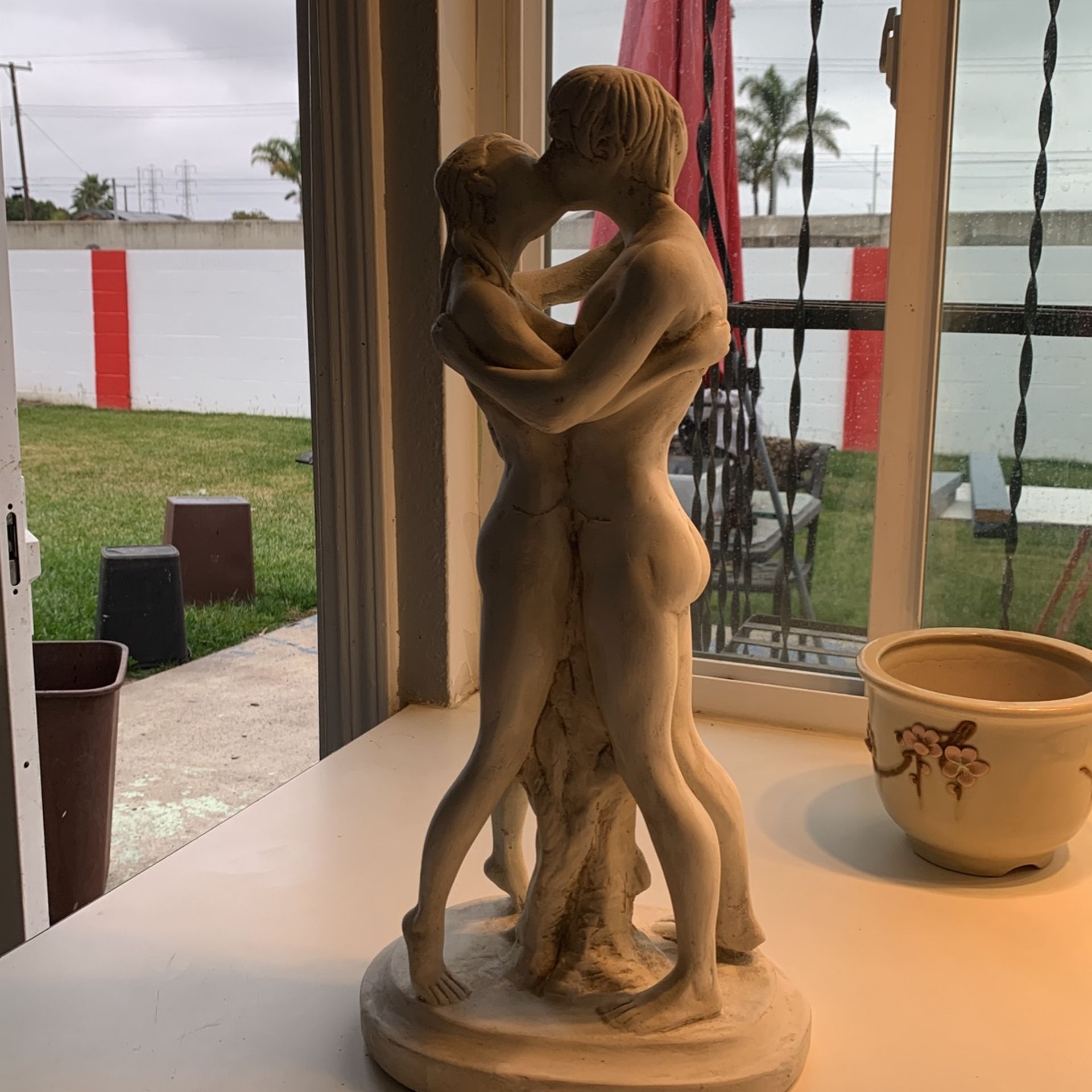 Statue of a woman, man kissing, very beautiful