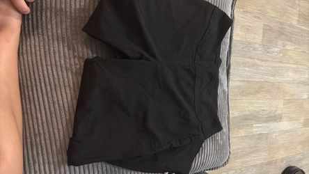 Black work pants with rose decals on the ankle
