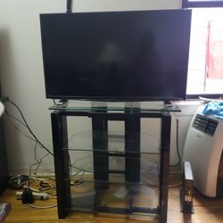 Flatscreen Tv With A Glass Stand 