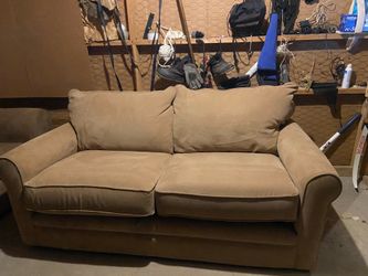 Beige sofa with bed inside.