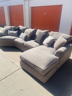 FREE DELIVERY!! gray-beige Ashley curved wedge sectional with right-facing chaise