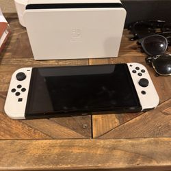 Selling a Nintendo Switch OLED console in great condition with accessories and Games 