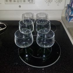 Wine glasses with a green spiral around the bottom.