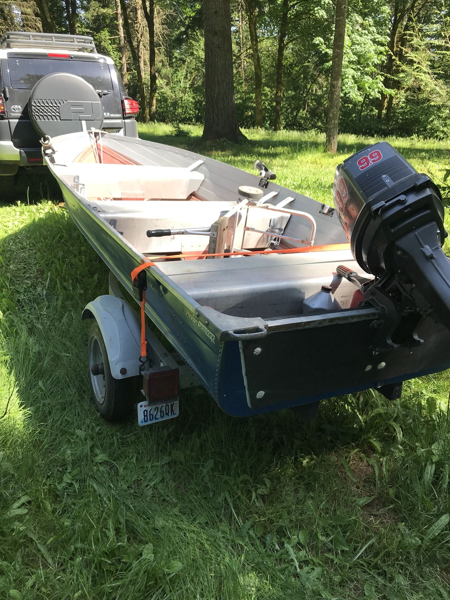 14’ aluminum boat with new 9.9hp engine and ez-loader trailer