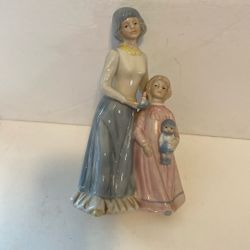 Mother with child. 9 inches tall. $10.