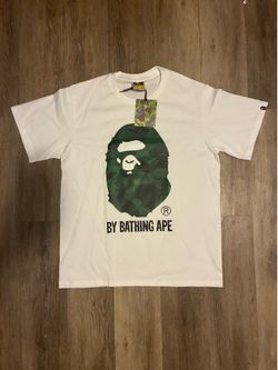 white t-shirt with green camouflage ape head graphic