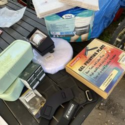 1 lot of misc brand new stuff. weight lifting braces. 26 yards of velcro. USB device. vitamins. 2 containers. prayer jar. adult diapers etc