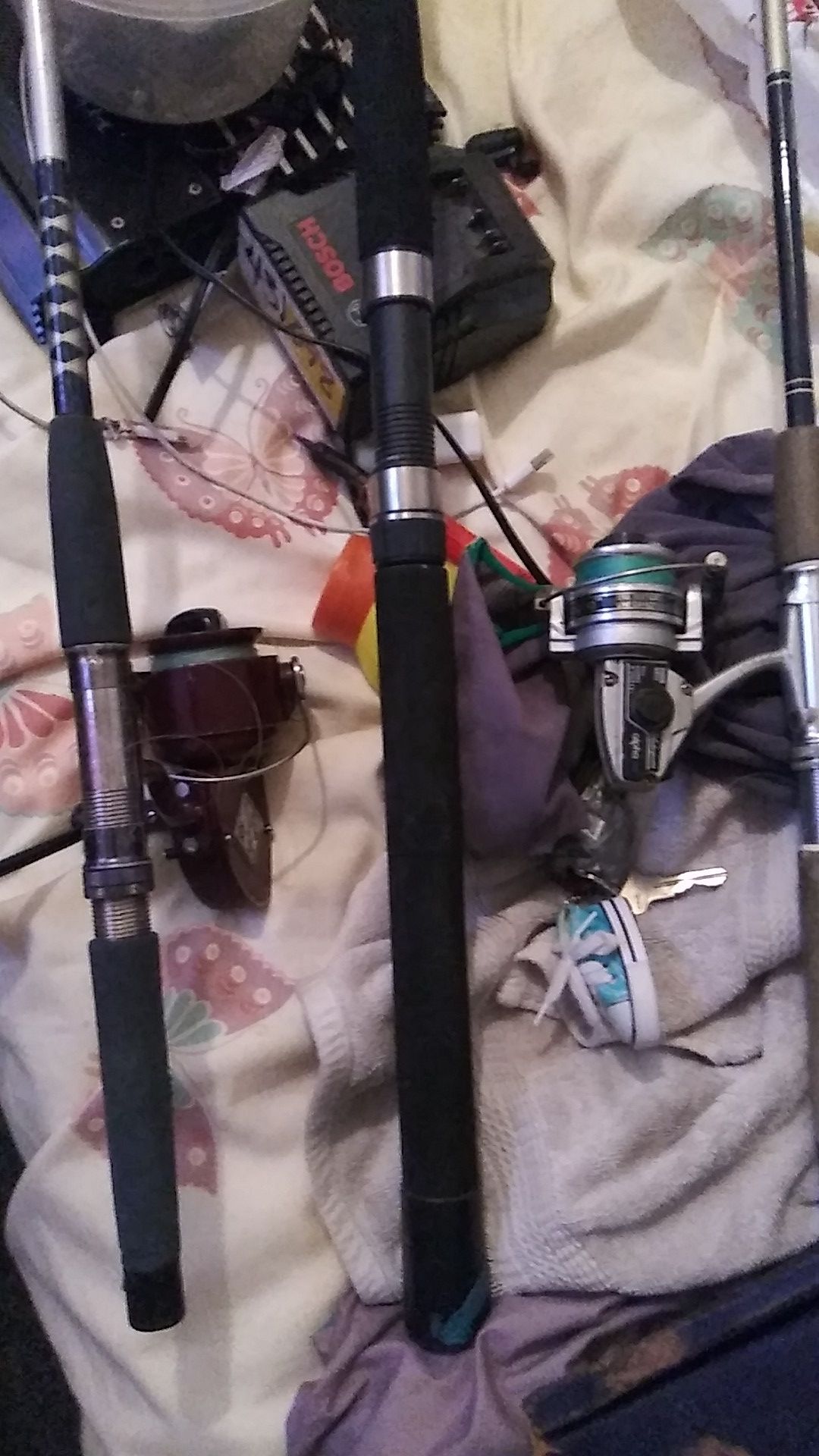 Three 8 ft fishing rods 2 with reels and string