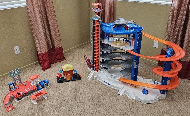 Hot Wheels Super Ultimate Garage, Hot Wheels Super City Firehouse Rescue Playset, and Matchbox Super Service Center Playset