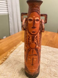 Vintage Africa pottery ceramic bud vase with ring handles & carved tribal mask designs. 10.5 inch