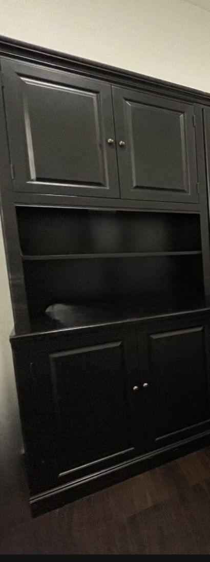 Black wood Thomasville book shelf with two cabinets and light.
