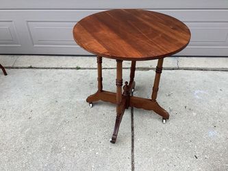 All wood round table on casters antique