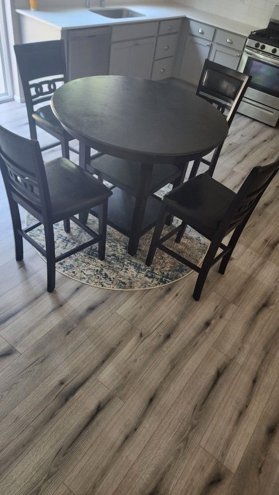 Counter height Round Table With Four Leather Chairs