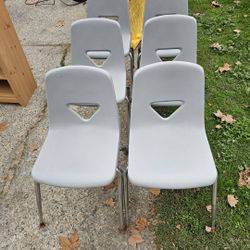 6 Plastic Chairs. Grey In Color. 