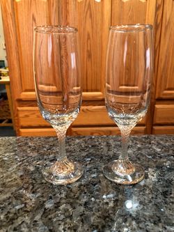 Crystal Champagne Flute Glasses set of 2 with a pretty designed stems. Size 7 inches tall. Brand New Never Used. Has been on display in a crystal