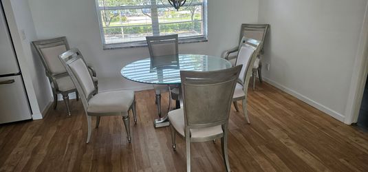 Glass top 54" round dining table and 6 chairs
