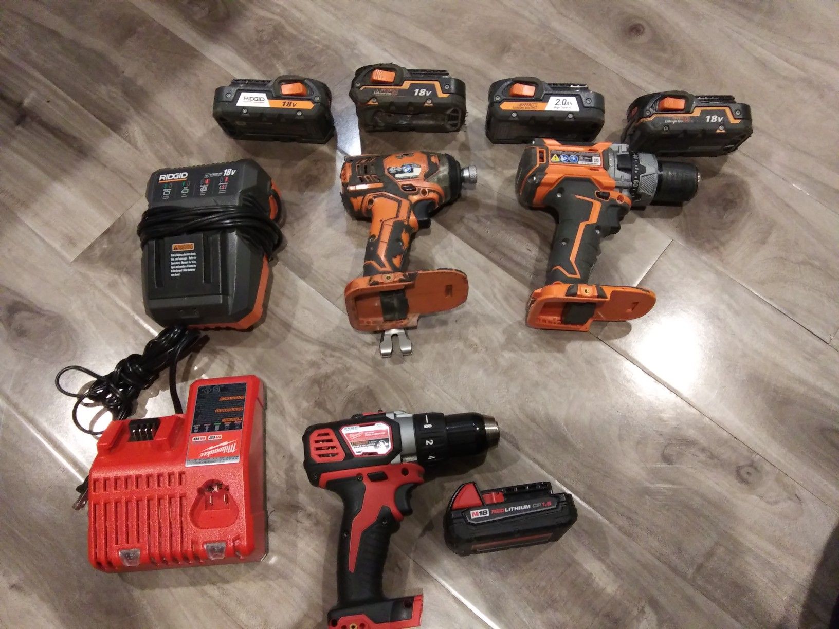 Impact and Ridgid hammer drill with 4 batteries and Milwaukee drill battery and charger