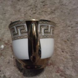 Gold and white embellished tea cup.