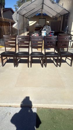 5 brown and black chairs
