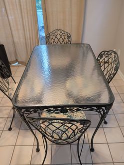 Wrought iron glass table 4 chairs