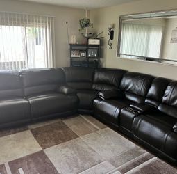 Brown leather couch seats 5 comfortably.