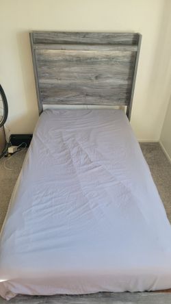 Ashley twin bed frame  with five built-in drawers and light fixtures and mattress from Matress firm