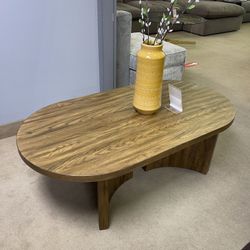 Austanny Warm Brown Oval Coffee Table