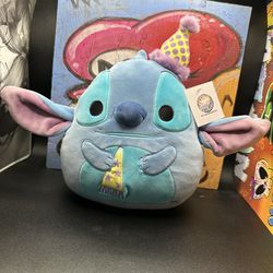 Squishmallows Disney Birthday Stitch wearing hat holding party favor 8"