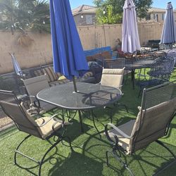 $300 Iron 4 ROCKING CHAIRS AND OVAL TABLE WITH CUSHIONS 