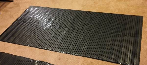 Exercise mat with grippers for equipment