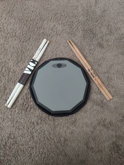 Drum practice pad with Vic drumsticks