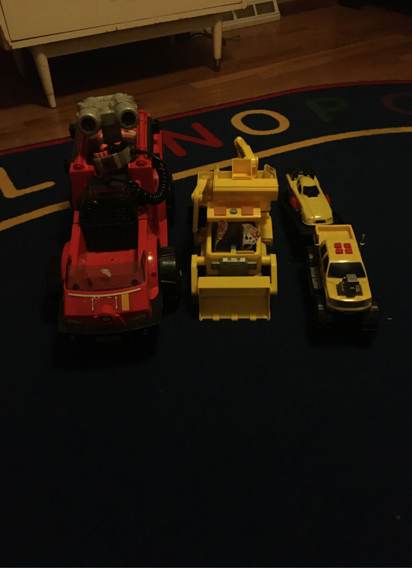 Paw patrol truck , fisher price truck, and random truck with trailer with race car